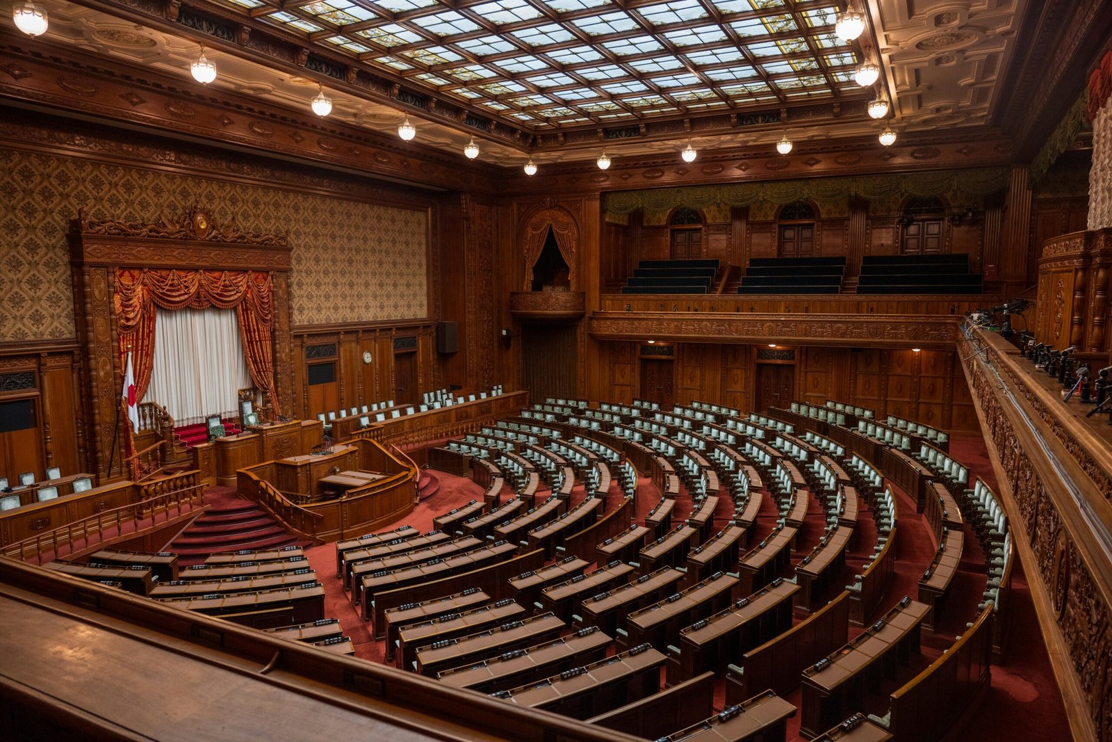 Captivating wide-angle view of a classic legislative assembly hall with ornate wood design.